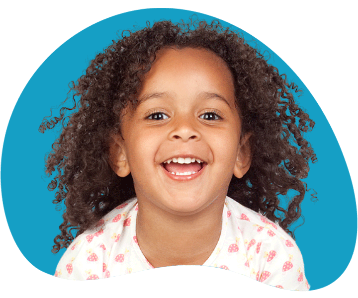 Curly haired kid smiling.