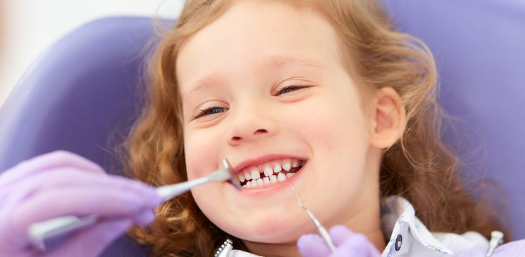 Young girl showing her teeth during a dental examination